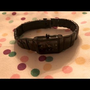 Black RADO watch with crystal details on the face.